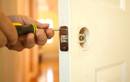 Handyman in Lafayette, LA fixing door.